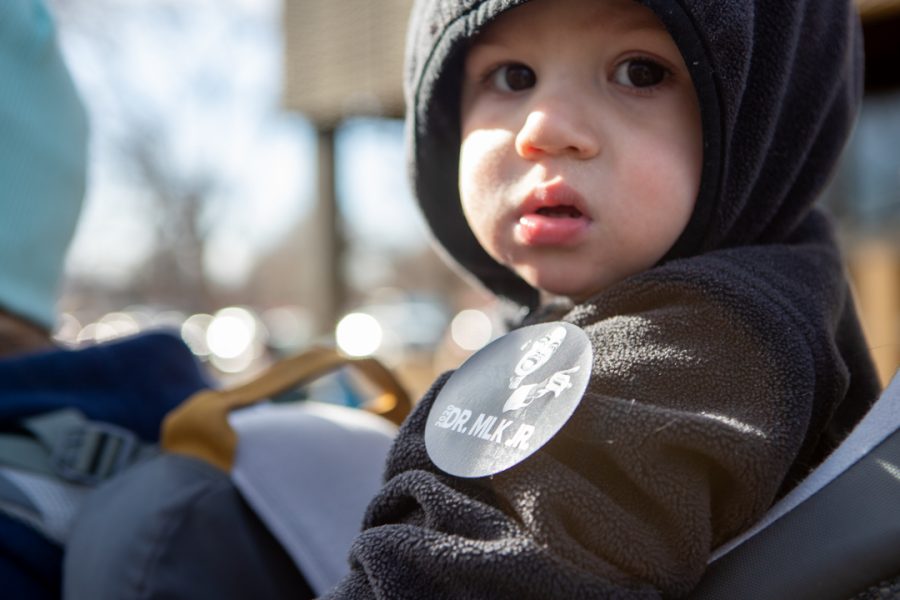 University of Northern Colorado Sociology student, Amber Goldstedt, and her son Jackson participate in the Dr. Martin Luther King Jr. Day march in downtown Fort Collins. "I want my son to experience being supportive in the community," Goldstedt said. (Brooke Buchan | The Collegian) 
