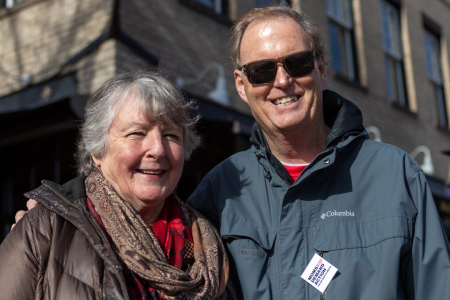 Fort Collins residents, Jean Grove (left) and Sean Shelley, participate in the Dr. Martin Luther King Jr. Day march in downtown Fort Collins. "We came out for social justice," Grove said. (Brooke Buchan | The Collegian)