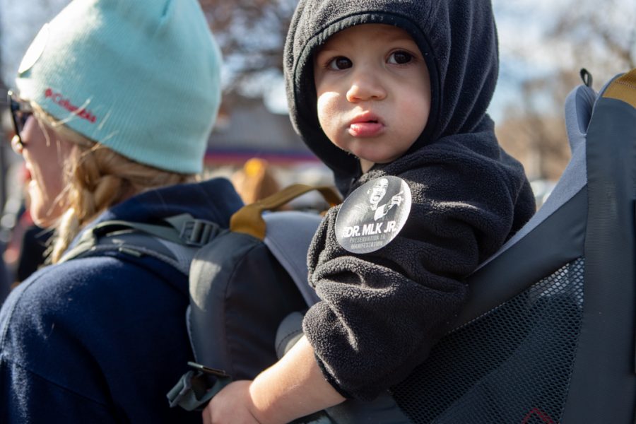 University of Northern Colorado Sociology student, Amber Goldstedt, and her son Jackson participate in the Dr. Martin Luther King Jr. Day march in downtown Fort Collins. "I want my son to experience being supportive in the community," Goldstedt said. (Brooke Buchan | The Collegian) 