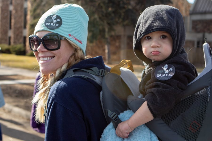 University of Northern Colorado Sociology student, Amber Goldstedt, and her son Jackson participate in the Dr. Martin Luther King Jr. Day march in downtown Fort Collins. "I want my son to experience being supportive in the community," Goldstedt said. (Brooke Buchan | The Collegian) 