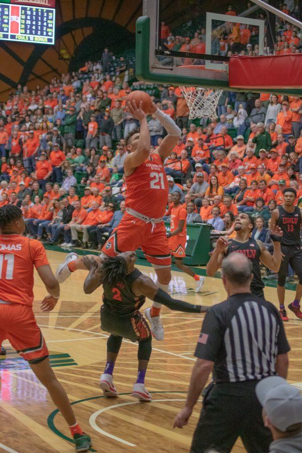 David Roddy (21) leaps over a defender and towards the basket, during the University's home game against the Las Vegas UNLV Rebels. CSU wins 95-77. (Devin Cornelius | Collegian)