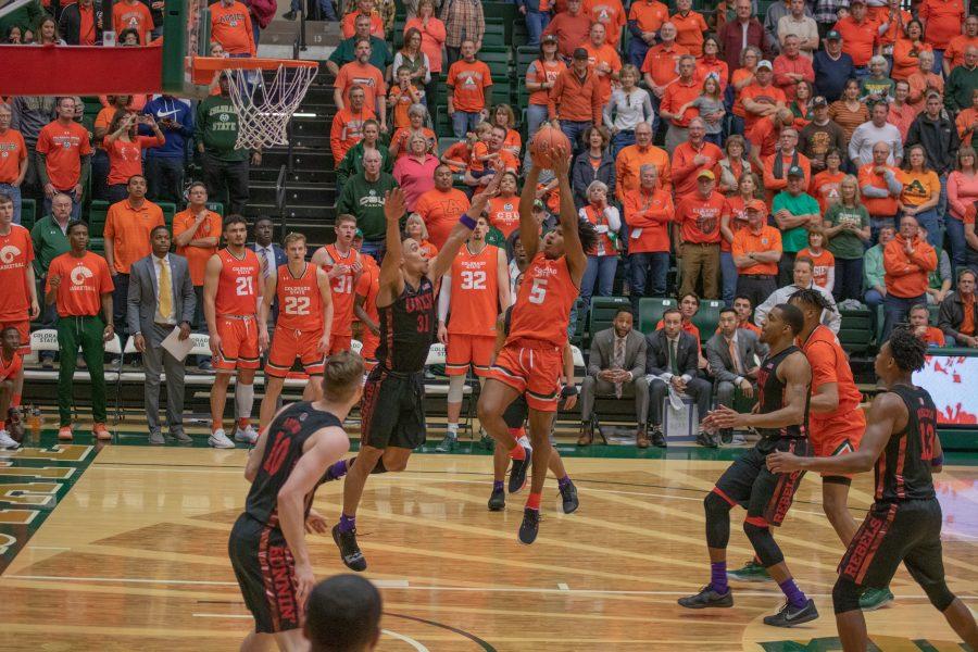 P.J. Bird (5) stretches up for a jump shot with an opponent attempting to block him, during the University's home basketball game vs the University of Nevada, Las Vegas. CSU wins 95-77. (Devin Cornelius | Collegian)
