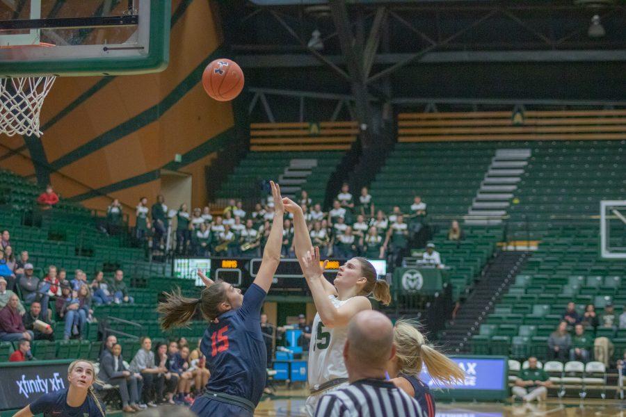 Lore Devos (35) dribbles around a defender and shoots over another, during the University's home game against Fresno State University. CSU falls to the Bulldogs 79-61. (Devin Cornelius | Collegian)