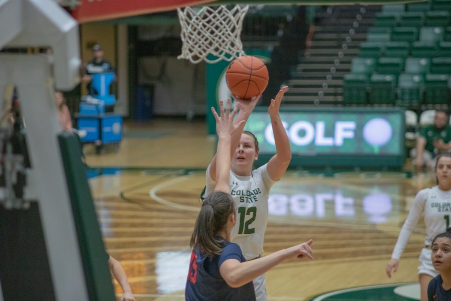 Jamie Bonnarens (12) shoots while a defender attempts to block, during the University's home game against Fresno State University. CSU falls 79-61. (Devin Cornelius | Collegian)
