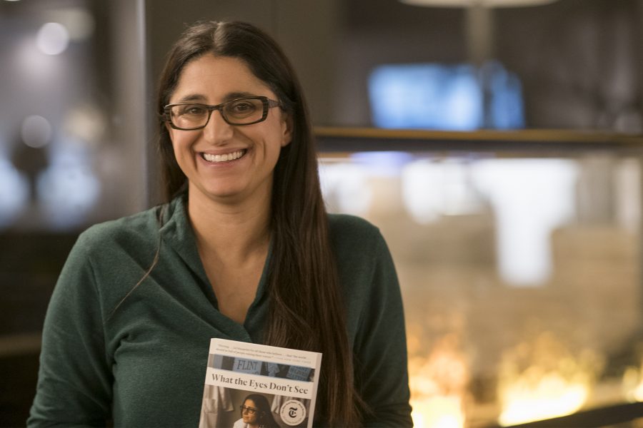 Dr. Mona Hanna-Attisha poses in the lobby of the Hilton in Fort Collins with her book “What the Eyes Don’t See”. (Lucy Morantz | The Collegian)