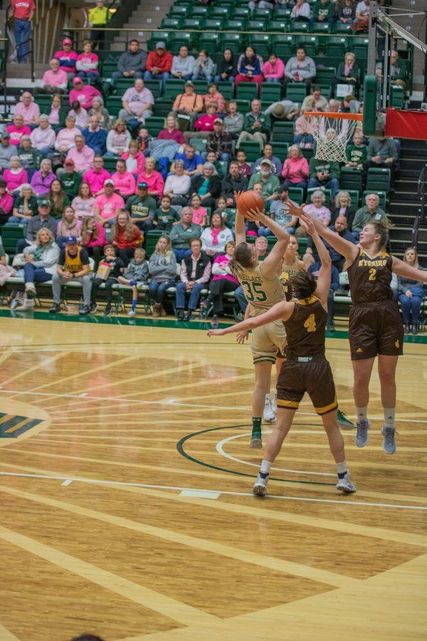 Lore Devos (35) shoots with two defenders guarding her, during the Colorado State home game vs Wyoming on Feb 15, 2020. CSU falls 43-40. (Devin Cornelius | Collegian)