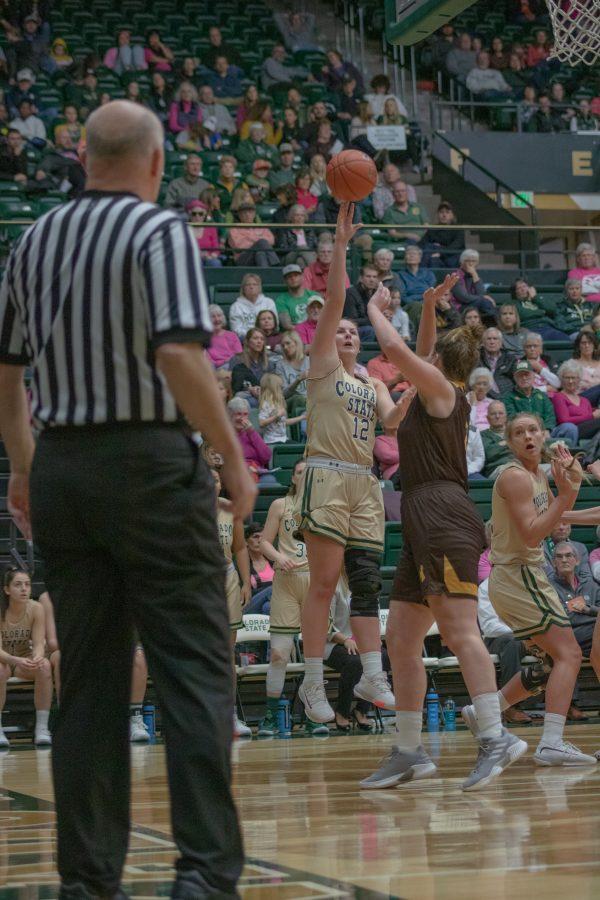 Jamie Bonnarens (12) shoots from beyond the arc over a defender, during the University home game vs Wyoming on Feb 15, 2020. CSU loses 43-40. (Devin Cornelius | Collegian)
