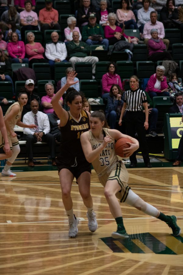 Lore Devos (35) drives towards the basket with a defender guarding her, during the University home game vs Wyoming on Feb 15, 2020. CSU loses 43-40. (Devin Cornelius | Collegian)