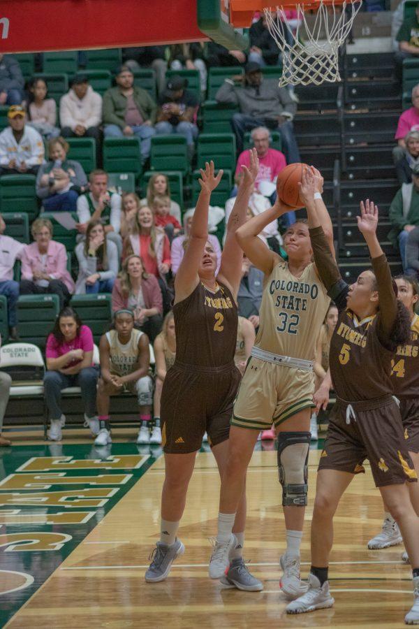 Andrea Brady (32) drives under the basket and attempts a layup with two defenders guarding her, during the University home game vs Wyoming on Feb 15, 2020. CSU loses 43-40.(Devin Cornelius | Collegian)