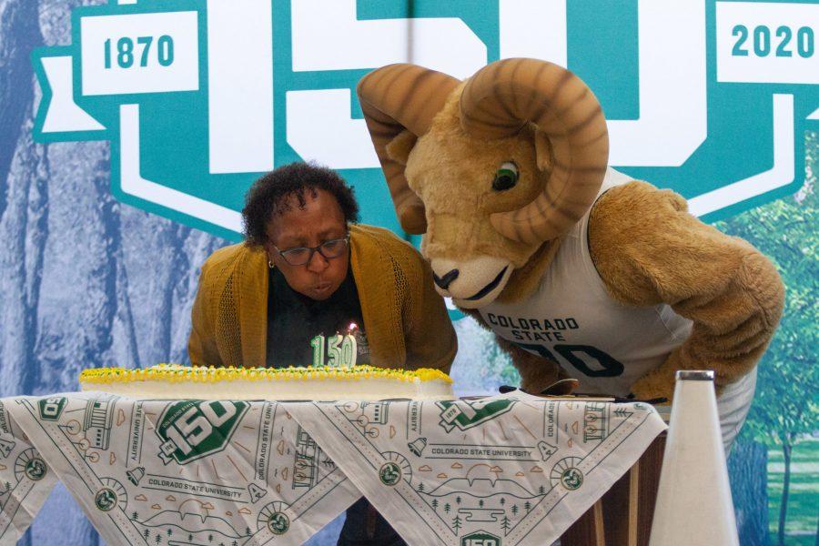 Blanche Hughes, Vice President for Student Affairs, and CAM the Ram blow out the candles on the cake for the Colorado State University 150-year birthday celebration Feb. 2. (Matt Tackett | The Collegian)