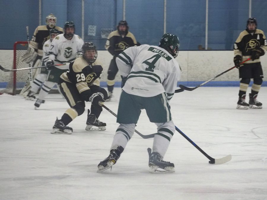 Colorado State defenseman Noah Miller possesses the puck in the Rams 3-2 win over the Colorado Buffaloes on Feb. 21. Miller had one of the Rams goals in the game.  (Gregory James | The Collegian)