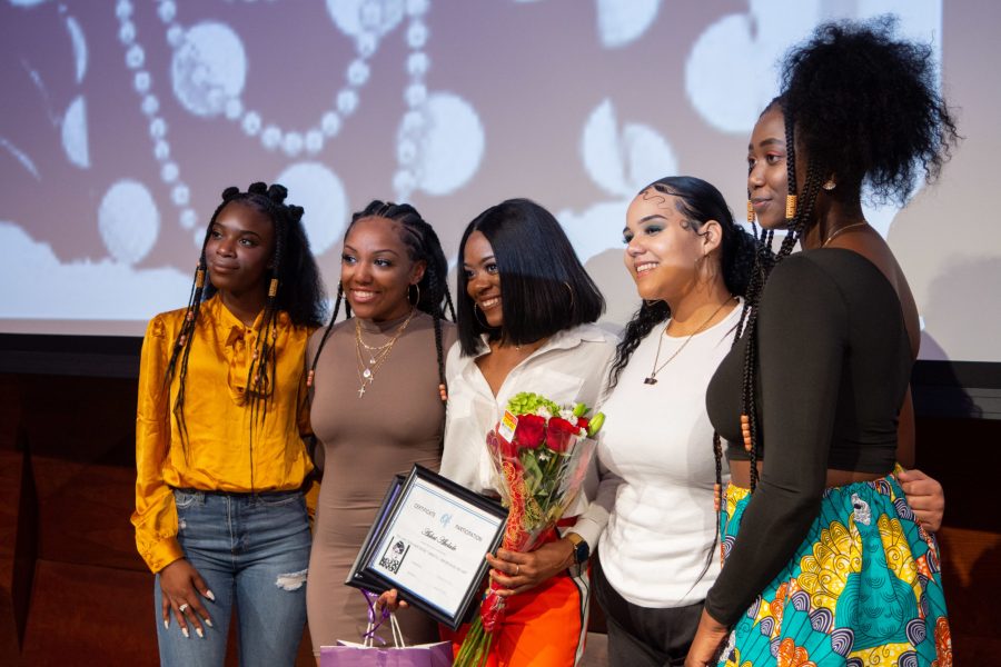 Members of the United Women of Color pose for a photo with winner Aishat Akolado after the annual Black History Month Hairshow in the Lory Student Center Theater, Feb 9. (Matt Tackett | The Collegian)
