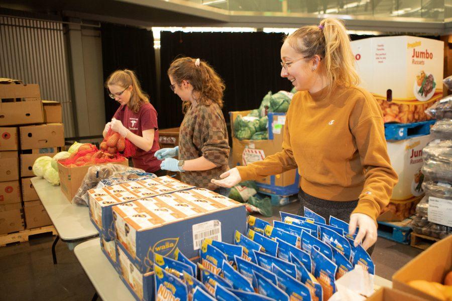 Teagan Bryan (right), Leora Greene, and Abbie Kucera volunteer at the Larimer County Food Bank, or Mobile Food Pantry, in the Lory Student Center Theatre Thursday night. I have lots of friends who are paying for college on their own, working, and struggling to get groceries for themselves. This is a fun way to give back to my own community and make sure my peers have enough food to get them through for a little while, said Greene. The Mobile Food pantry is on campus the first Wednesday or Thursday of each month. (Brooke Buchan | The Collegian) 