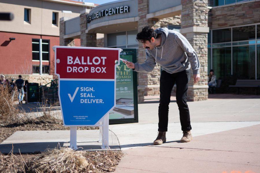 Jairus Crabb drops off their ballot at the ballot box outside of the Lory Student Center on Super Tuesday, March 3, 2020. (Matt Tackett | The Collegian)
