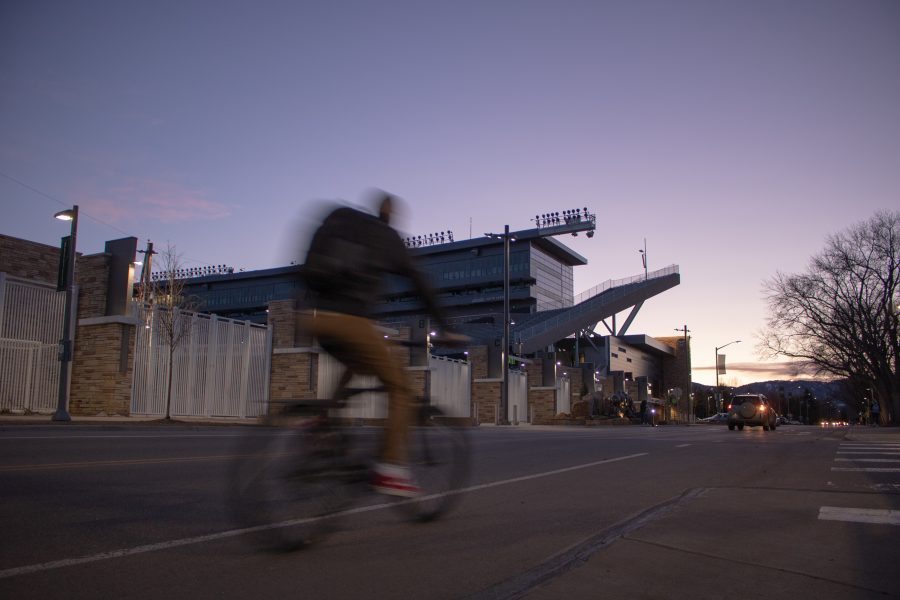 A biker rides past Canvas Stadium on Mar. 4, 2020. The Stadium is where Colorado State football plays at. (Devin Cornelius | Collegian)