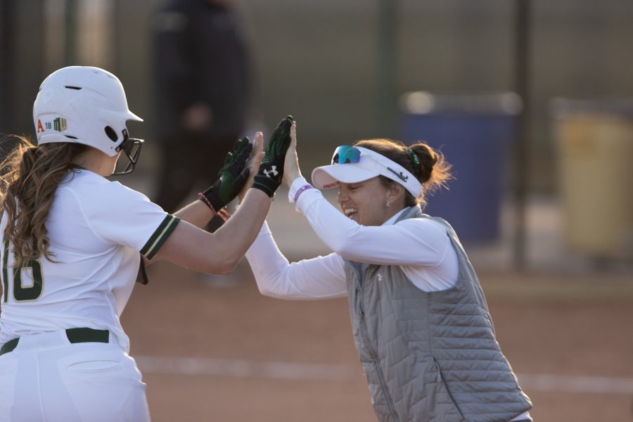 Ashley Ruiz (18) high fives Coach Fisher after hitting a homerun, during the University's first game against Purdue University at the Colorado State  during the (Devin Cornelius | Collegian)