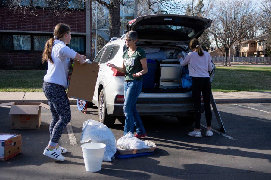 Colorado State University biomedical sciences freshman Chaia Geltser (left) is helped by her mother Anna Geltser (center) and sister Ettie Geltser (right) to load their car after moving out of Ingersoll Hall March 25. “It probably is for the best but it’s tough for sure,” said Chaia Geltser. “I think that CSU organized it really well though.” (Matt Tackett | The Collegian)