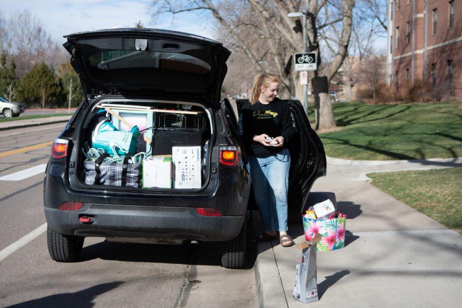 Colorado State University landscape architecture major and freshman Camy Seelhoff loads her family’s car while moving out of Aspen Hall March 25 following the request by the CSU administration for freshmen to move out of the dorms if they can. (Matt Tackett | The Collegian)