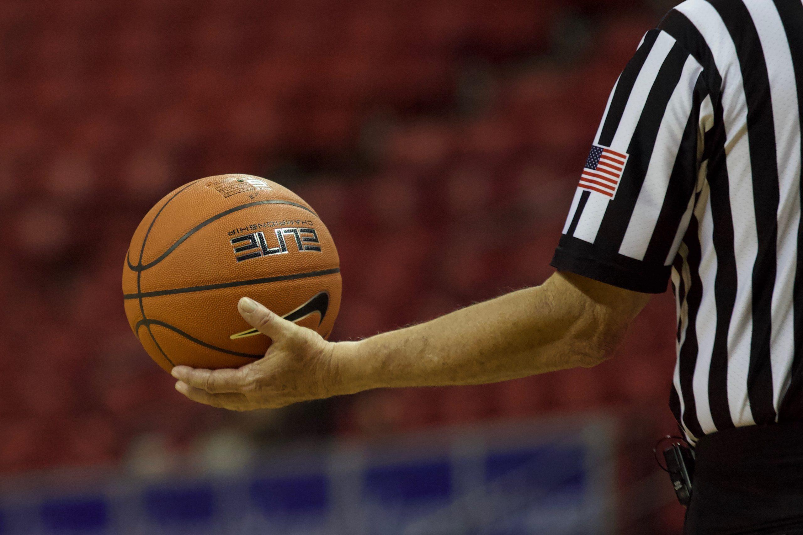 referee holding basketball