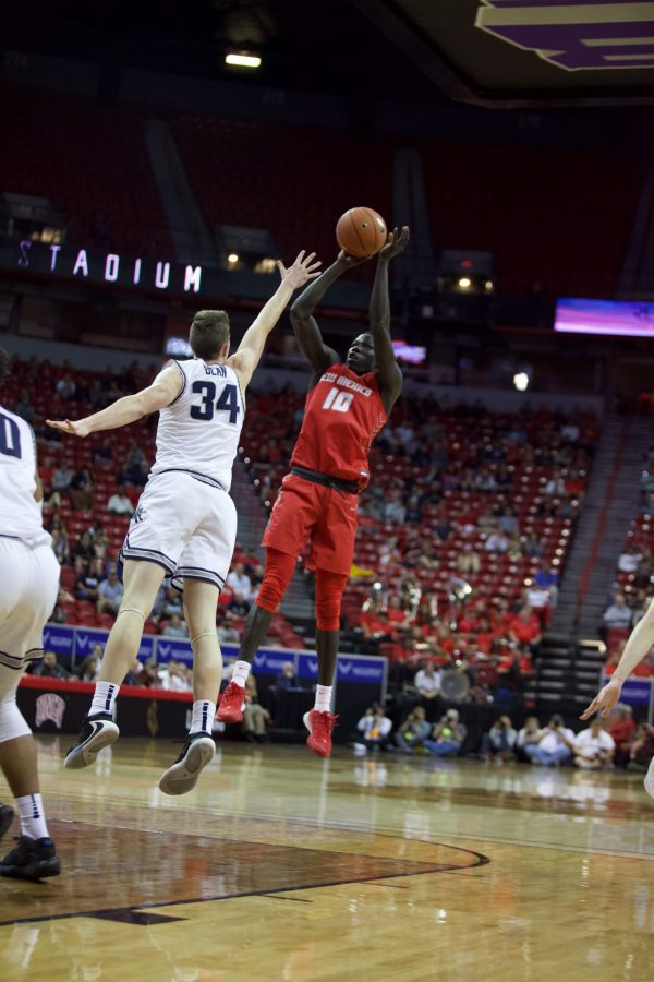 Makuach Maluach shoots on Mar. 05. Through an emotional game, Utah State beat New Mexico 75-70. (Ryan Schmidt | The Collegian)