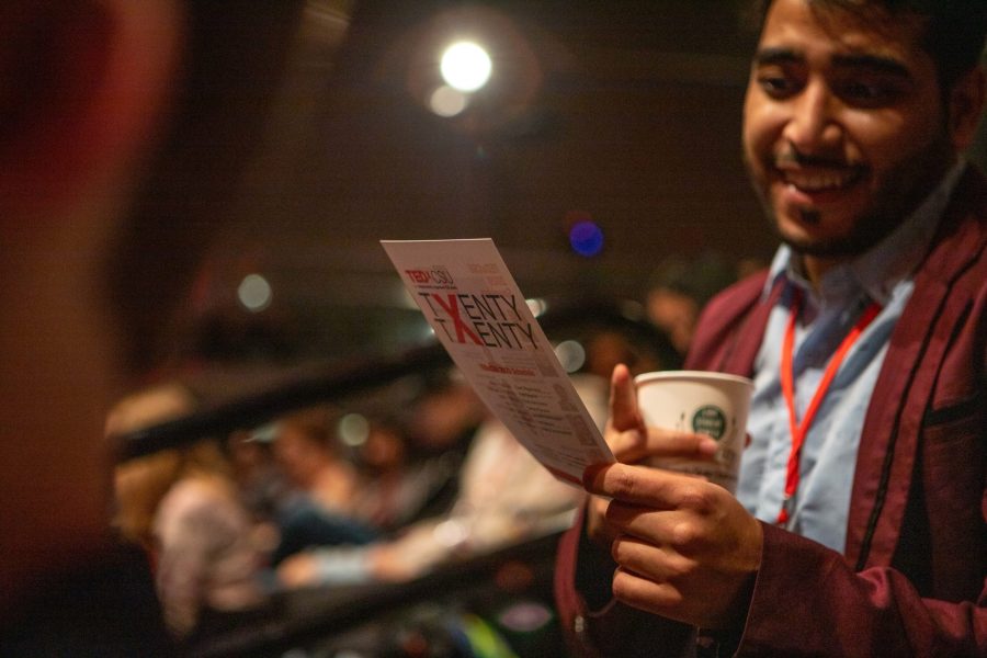 A visitor holds up a TEDx CSU flyer in the audience of the Lory Student Center during the 2020 TEDx CSU event Saturday morning. TEDx is a local, community-organized gathering of people who give TED-like talks and performances around central ideas. This years TEDx CSU event organized around the theme of, Momentum, and featured key speakers, performers and poets in the Fort Collins community. (Brooke Buchan | The Collegian) 