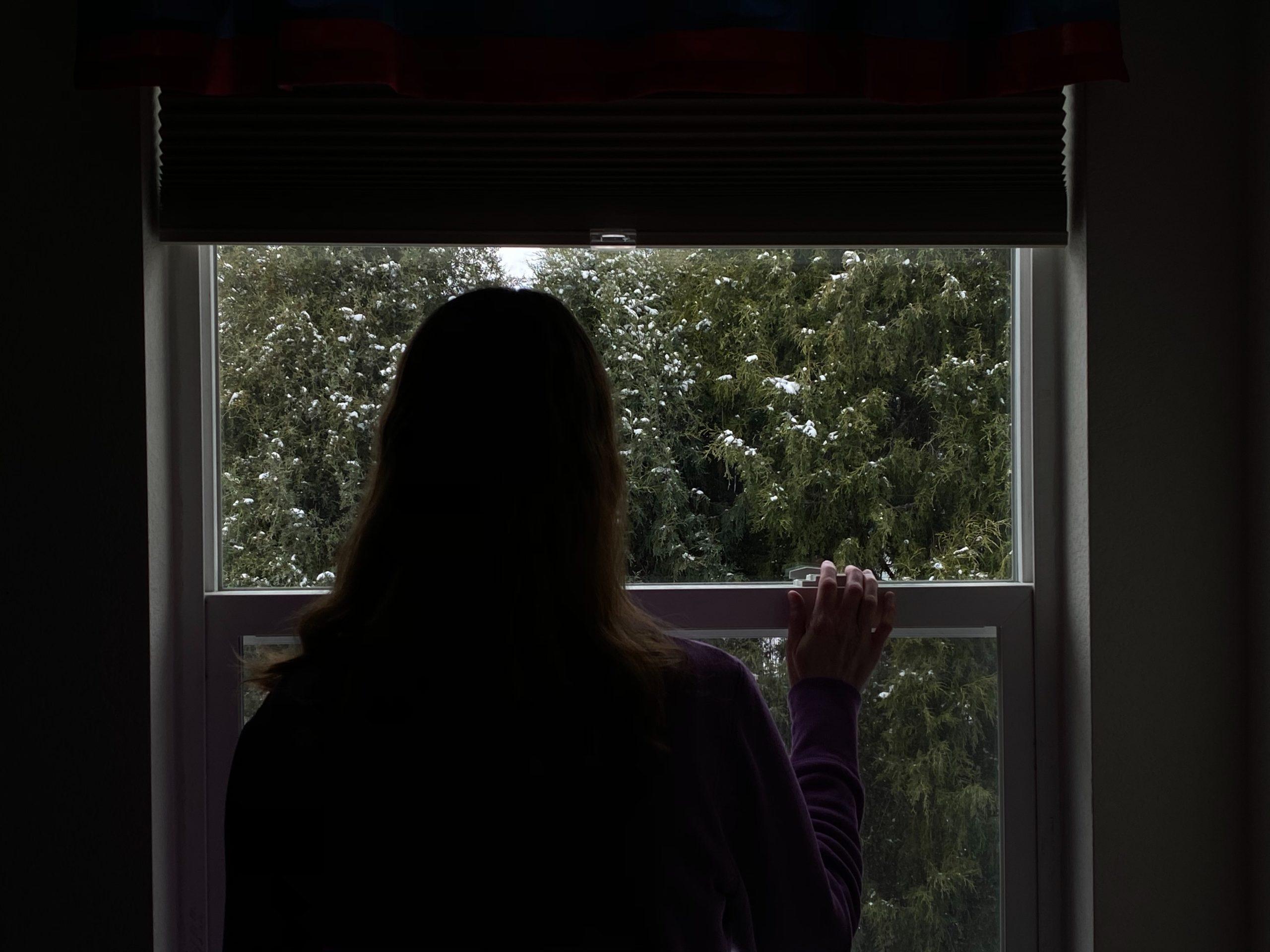 woman standing in front of window