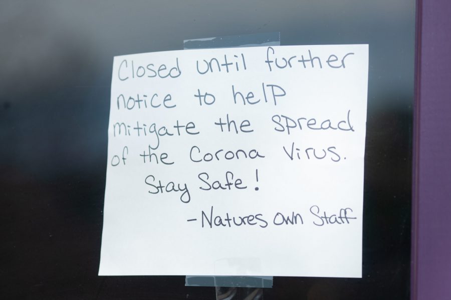 A closed notice hangs on the window of Natures Own in downtown Fort Collins, similar to signs in most other downtown business windows. Effective March 26, Larimer County Public Health Director Tom Gonzales issued a Stay at Home order requiring all individuals in Larimer County to stay at home except for food and essential services. There are currently 127 confirmed-positive cases of COVID-19 in Larimer County, and five confirmed deaths. (Brooke Buchan | The Collegian) 