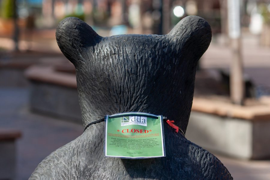 A closed sign hangs on the back of a bear statue in an interactive park in downtown Fort Collins. Effective March 26, Larimer County Public Health Director Tom Gonzales issued a stay-at-home order requiring all individuals in Larimer County to stay at home except for food and essential services. (Brooke Buchan | The Collegian) 