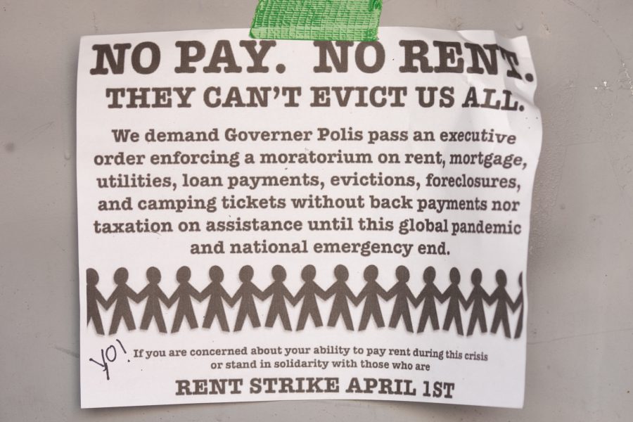 A sign proposing a rent-strike for April 1 hangs on a door in downtown Fort Collins. Effective March 26, Larimer County Public Health Director Tom Gonzales issued a Stay at Home order requiring all individuals in Larimer County to stay at home except for food and essential services. There are currently 127 confirmed-positive cases of COVID-19 in Larimer County, and five confirmed deaths. (Brooke Buchan | The Collegian) 