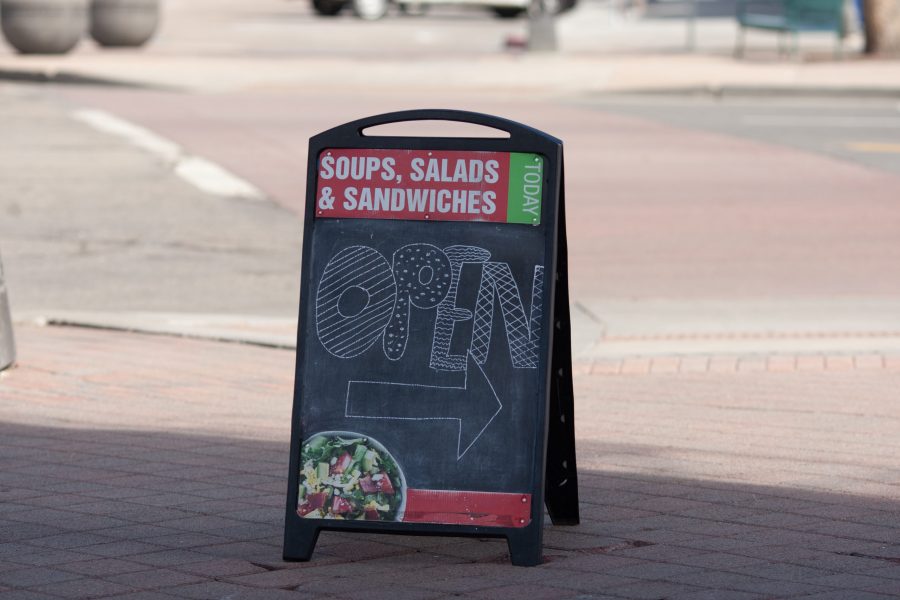 An open sign stands outside the soup and sandwich shop Spoons in downtown Fort Collins. Effective March 26, Larimer County Public Health Director Tom Gonzales issued a Stay at Home order requiring all individuals in Larimer County to stay at home except for food and essential services. There are currently 127 confirmed-positive cases of COVID-19 in Larimer County, and five confirmed deaths. (Brooke Buchan | The Collegian) 