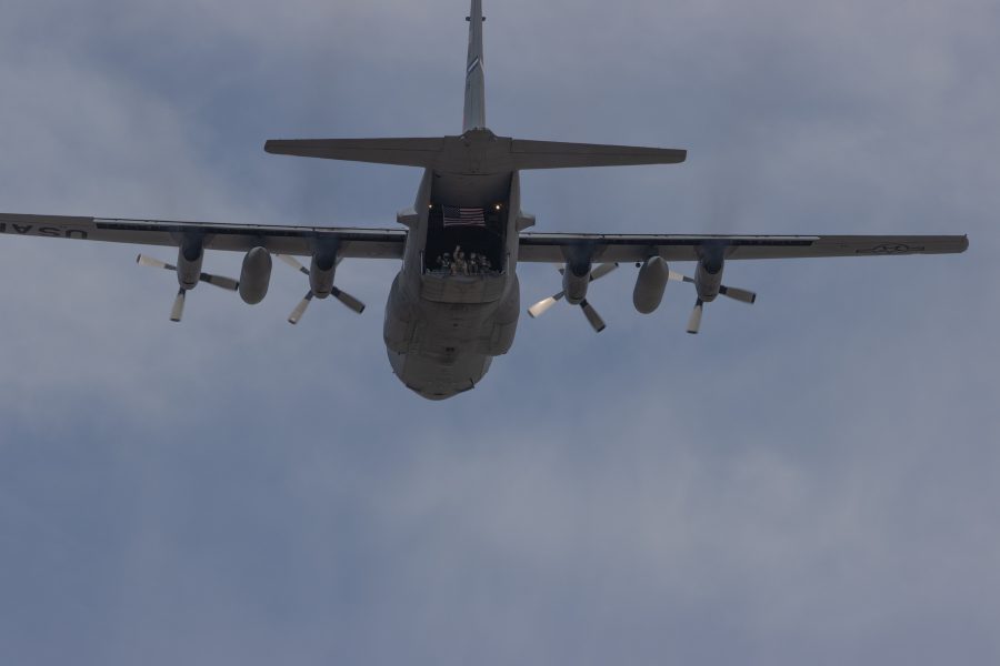 People wave from the back of a Lockheed C-130 Hercules as it flies over UCHealth Poudre Valley Hospital to show support for essential, and healthcare workers on May 6, 2020. (Devin Cornelius | Collegian)