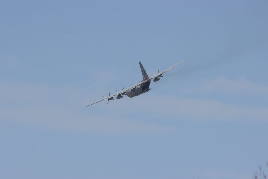 People sit in the tail of a C-130 as it flies over UCHealth Poudre Valley Hospital to show support for essential and healthcare workers on May 6, 2020. (Devin Cornelius | Collegian)