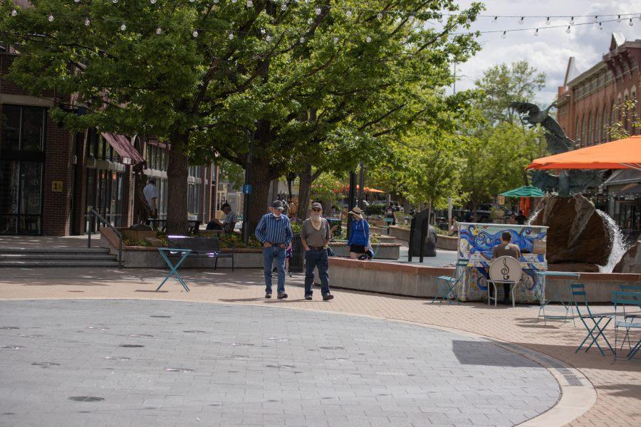 People relax in Old Town Square after a variance request was approved allowing restaurants in Larimer County are clear to re-open dine-in services at limited capacity. (Devin Cornelius | Collegian)