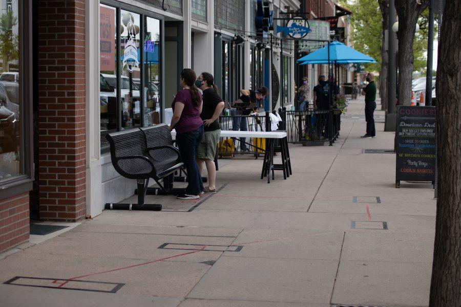 People order cookies from the outside window of Mary's Cookies in Old Town. A special variance request has allowed restaurants to re-open dine-in service with limited capacity in Larimer County.(Devin Cornelius | Collegian)