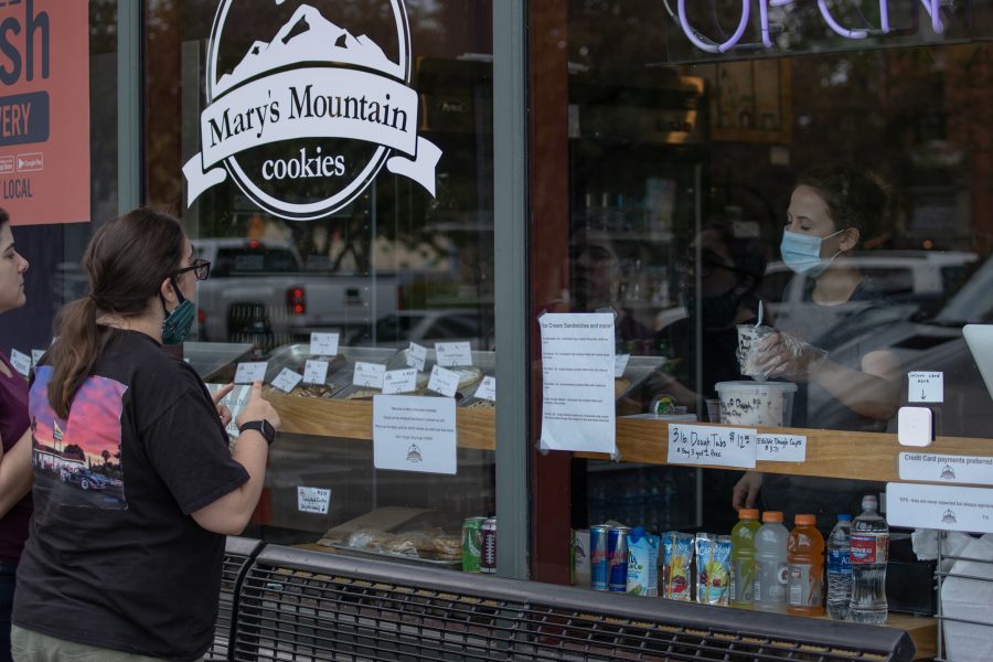 People order cookies from the outside window of Mary's Cookies in Old Town. A special variance request has allowed restaurants to re-open dine-in service with limited capacity in Larimer County.(Devin Cornelius | Collegian)