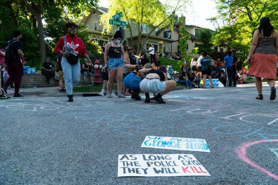 The signs of demonstrators as they use chalk to draw Black Lives Matters imagery. The protests are in response to the killing of George Floyd. Thursday, May 28, 2020. (Photo courtesy of Ben Leonard)