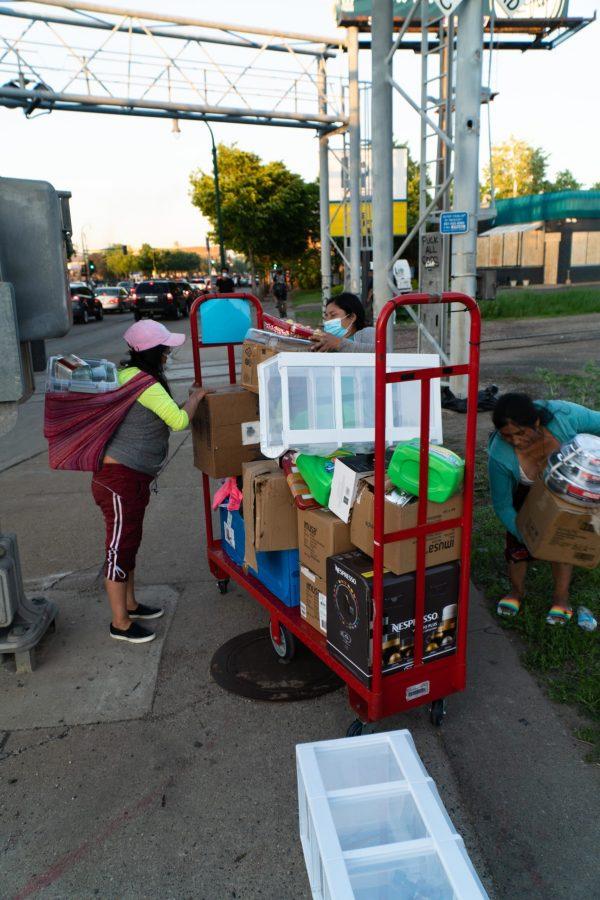 3 women gathering and organizing items they looted from the Targert store across the street. The looting stemmed from protests started in repsonse to the murder of George Floyd. Thursday, May 28, 2020. (Photo courtesy of Ben Leonard)