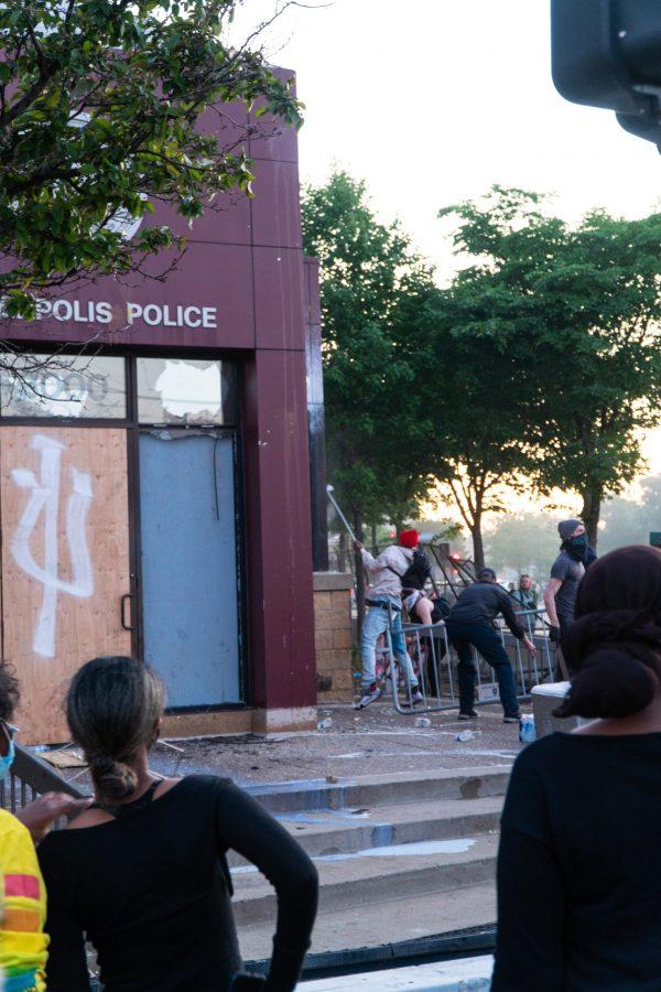 People tearing down the fence that was in front of the Minneapolis PDs 3rd precinct and beginning to smash windows. The riots were in repsonse to the murder of George Floyd. Thursday, May 28, 2020. (Photo courtesy of Ben Leonard)