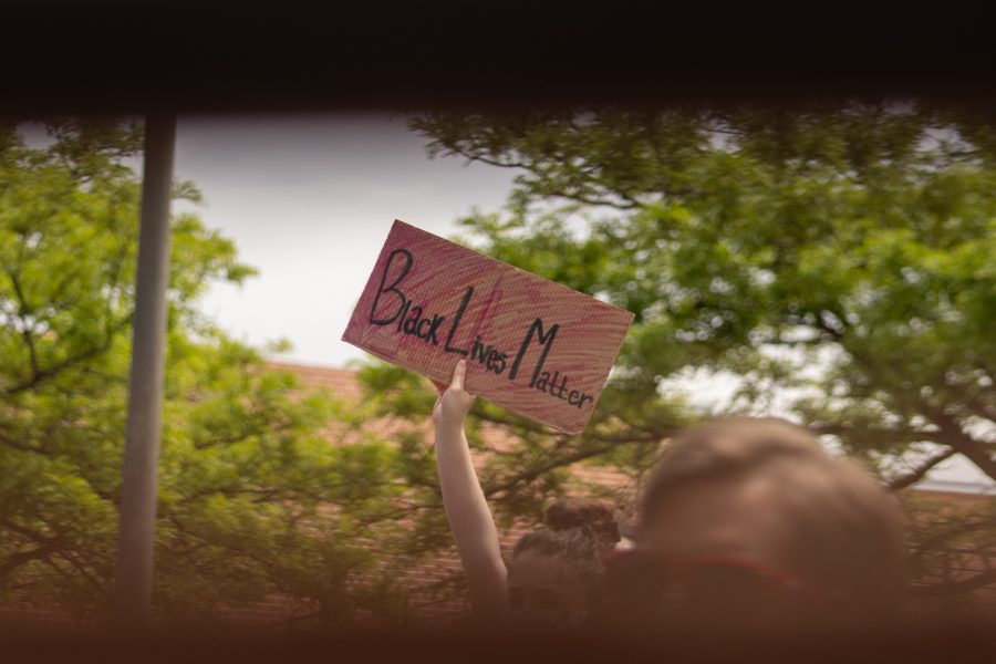 A protester holds up a sign that says “Black Lives Matter” during a speech at a protest in Old Town Square on June 2. (Devin Cornelius | The Collegian)