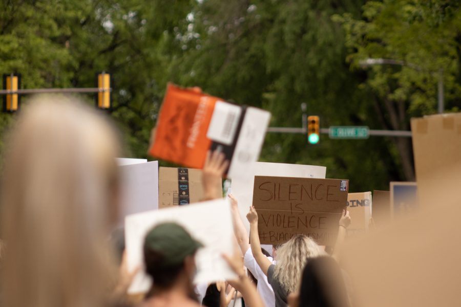 Protesters hold up signs as they march towards City Hall in Fort Collins on June 2, 2020. (Devin Cornelius | Collegian)