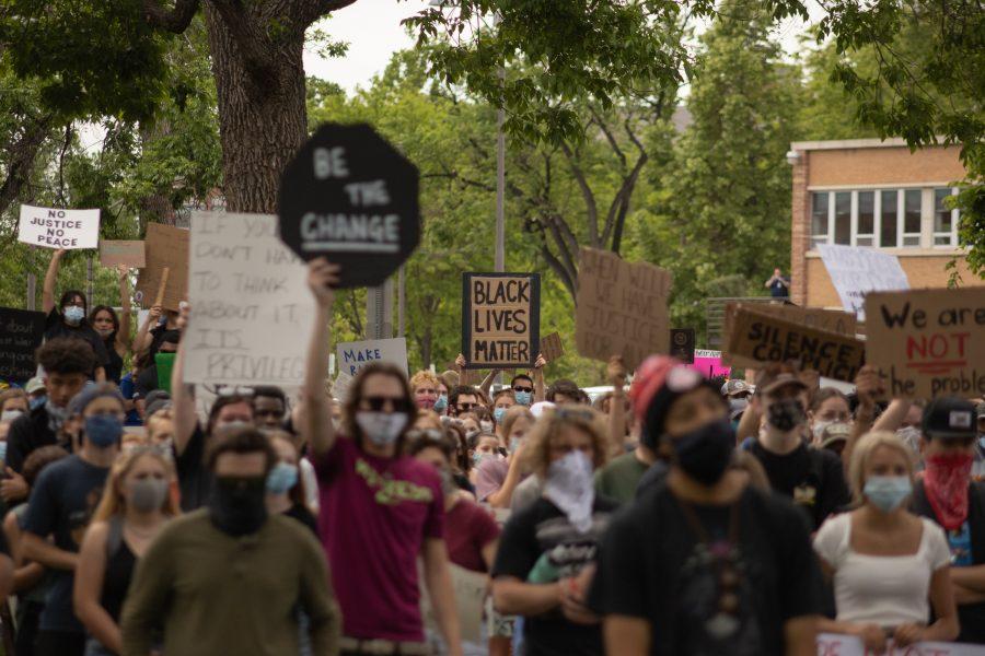 Protesters hold up signs as they protest by Town Hall on June 2, 2020. (Devin Cornelius | Collegian)
