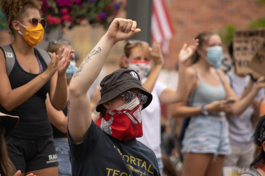 A protester raises his fist during a protest in Old Town Square on June 5, 2020. (Devin Cornelius | Collegian)