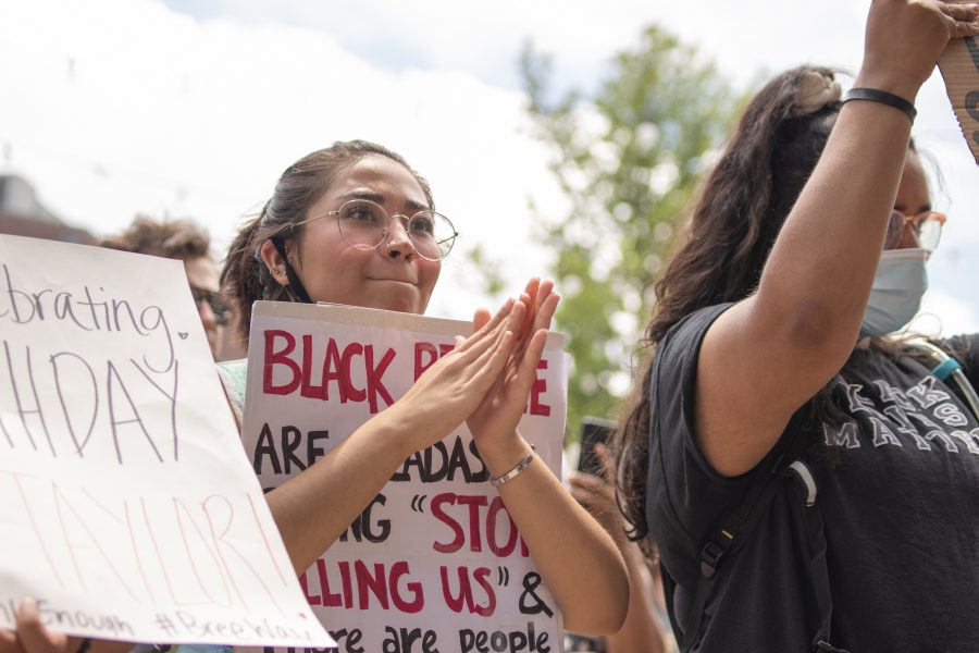 A protester claps as a speaker talks to the crowd in Old Town Square June 5. (Devin Cornelius | The Collegian)