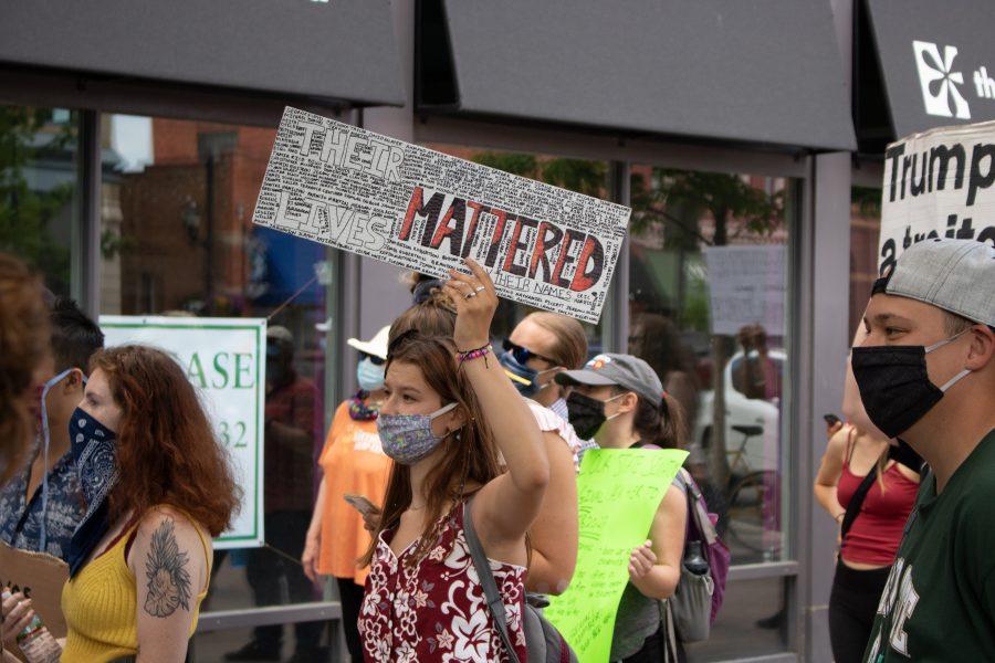 A woman holds a sign as hundreds of protesters march through Old Town protesting against police brutality of black people, on June 5, 2020. (Devin Cornelius | Collegian)