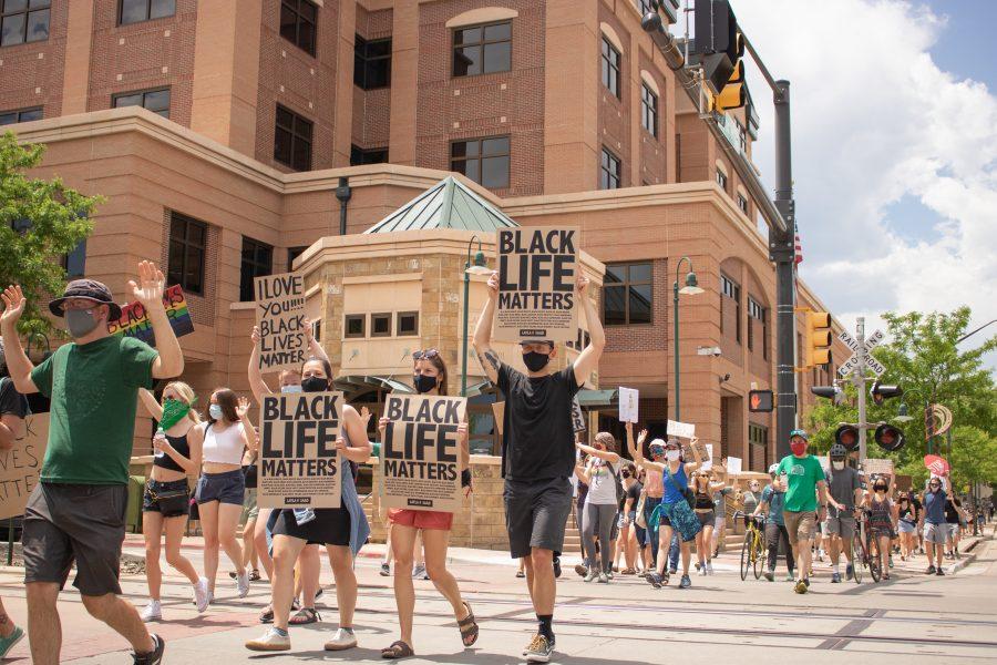 Hundreds of protesters march past the Larimer County Justice Center during a protest against police brutality on June 5, 2020. (Devin Cornelius | Collegian)