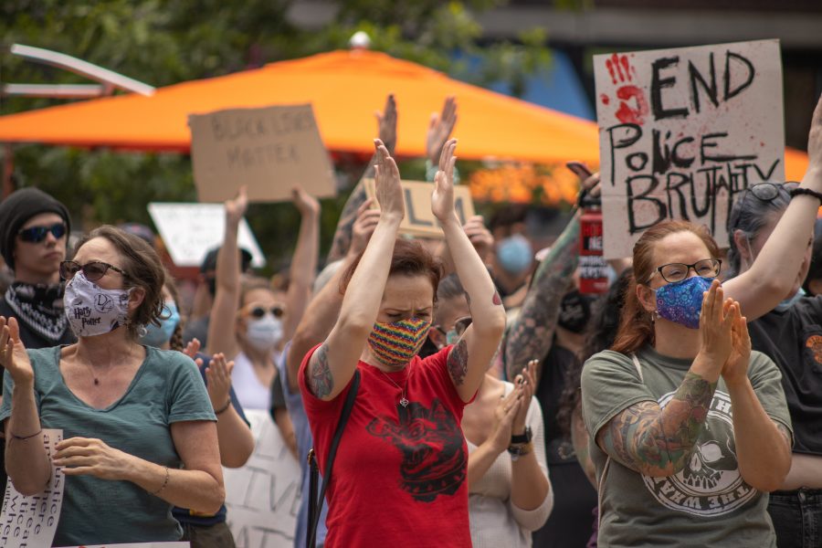 Protesters clap after the speaker finishes their speech at a protest in Old Town Square on June 5, 2020.  (Devin Cornelius | Collegian)