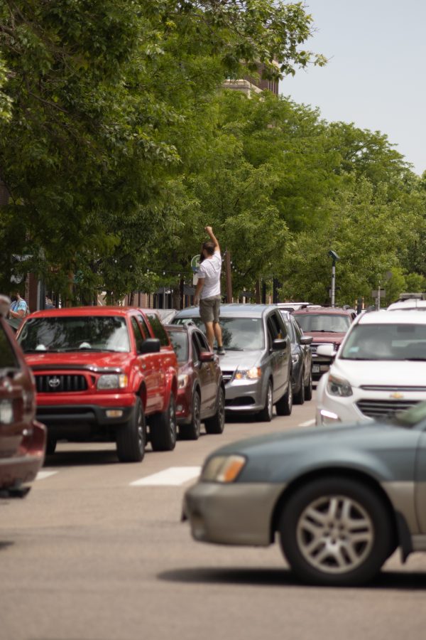 A man stands on his car while traffic is stopped due to protesters marching in Old Town, on June 5, 2020. (Devin Cornelius | Collegian)