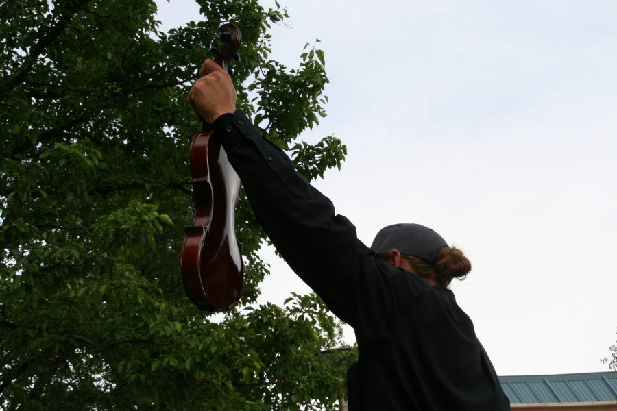 A protestor holds up their violin in solidarity with Elijah McClain, who played violin. Instruments were a large theme of the protest on June 27.(Katrina Leibee | The Collegian).