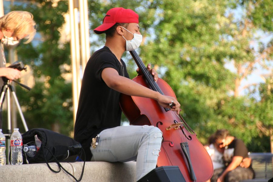 A cellist plays for protestors outside the Aurora Municipal Center on June 27. Protestors were asked to bring their string instruments in honor of Elijah McClain played violin (Katrina Leibee| The Collegian).