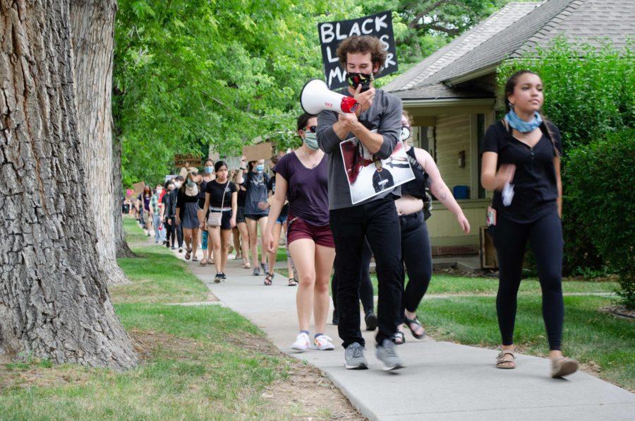Roesler took the megaphone near the end of the march. The protestors were responding with less enthusiasm. (Reed Slater | Collegian)